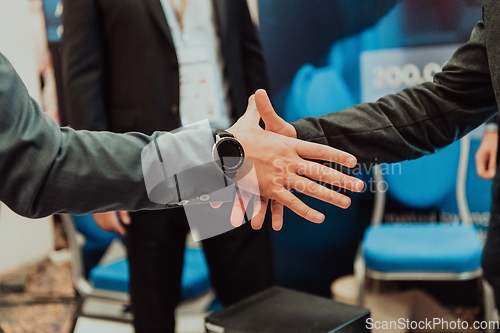 Image of Close up a handshake, businessman together creates a mutually beneficial business relationship. The economic graph on the table