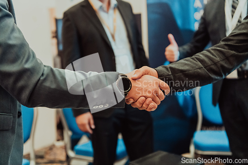 Image of Close up a handshake, businessman together creates a mutually beneficial business relationship. The economic graph on the table