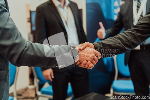 Image of Close up a handshake, businessman together creates a mutually beneficial business relationship. The economic graph on the table