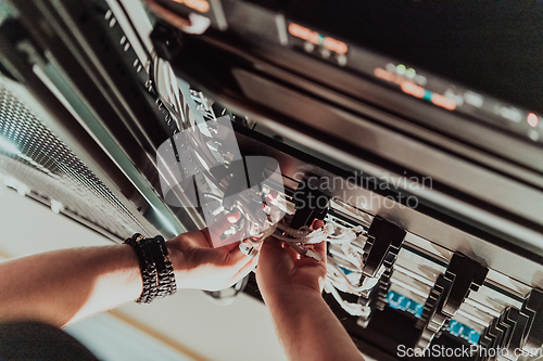 Image of Close up of technician setting up network in server room