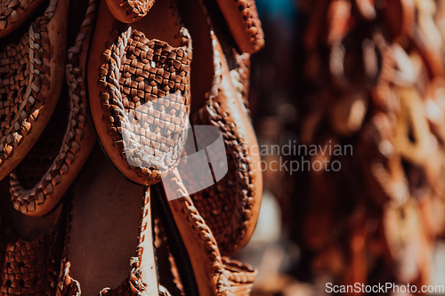 Image of Macedonian folklore, brown sandals. Old shoes. Part of the tradition. Black pants, close up