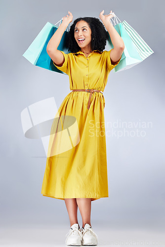 Image of Excited, celebration and woman with shopping bag for fashion in studio isolated on a white background. Smile, sales and African customer with gift, discount deal or clothes from store, retail or mall