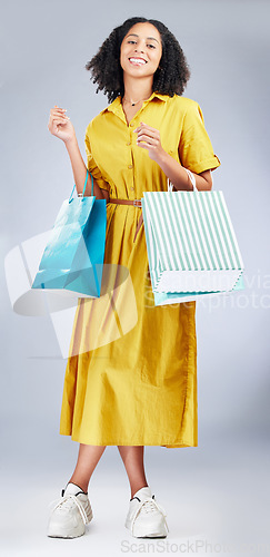 Image of Portrait, shopping bag and a woman in studio for fashion sale, promotion or retail discount. African female model or happy customer on a white background for advertising commerce offer, deal or gift