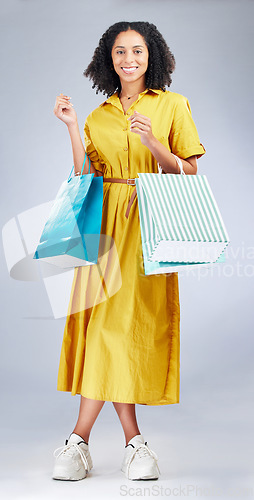 Image of Portrait, smile and woman with shopping bag for fashion in studio isolated on a white background. Happy, sales and African customer with gift, discount deal or clothes from shop, mall or retail store
