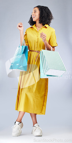 Image of Thinking, smile and woman with shopping bag for fashion in studio isolated on a white background. Happy, sales and African customer with gift, discount deal or clothes from shop, mall or retail store