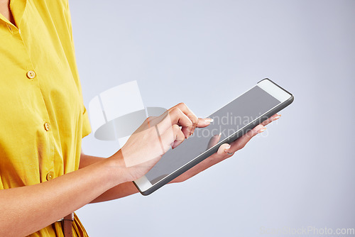 Image of Hands, tablet and closeup of a woman in studio scrolling on social media, mobile app or the internet. Online, research and female person browsing on website with digital technology by gray background