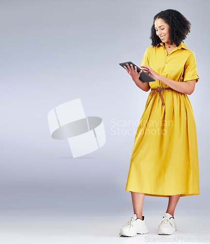 Image of Tablet, mockup and woman in a studio for online shopping with a sale, deal or promotion. Fashion, happy and full body and young female person with digital technology for ecommerce by gray background.