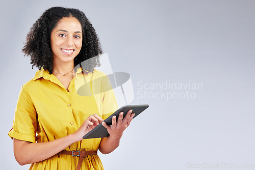 Image of Smile, email and portrait of a woman with a tablet on a studio background for communication. Happy, work and a young girl or employee typing on technology with mockup space for an app or internet