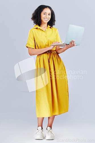 Image of Happy, blog and portrait of a woman with a laptop for communication, email or internet. Smile, technology and a girl or employee typing on a computer online for work isolated on a studio background