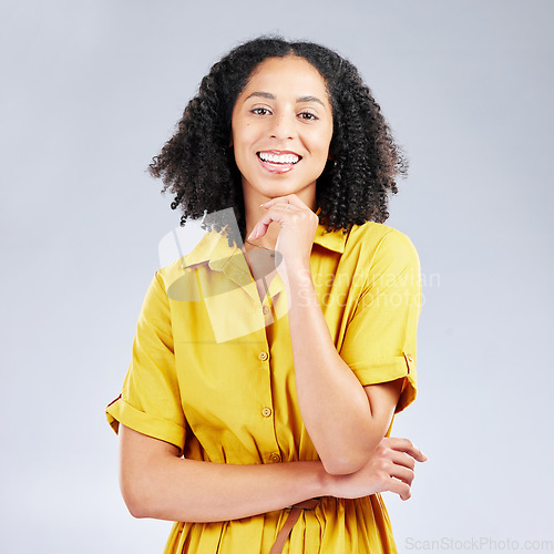 Image of Portrait, fashion and smile with a model woman in studio on a gray background for trendy style. Yellow, beauty and a happy or confident young female person with an afro posing in a clothes outfit