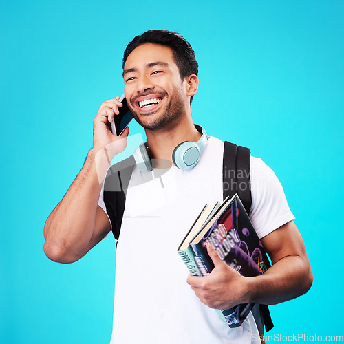 Image of Talking, phone and college student in studio with backpack for university, education and studying books on blue background. Happy, man and person excited for learning and mobile network connection