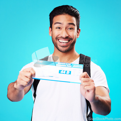 Image of Travel, ticket and portrait of Asian man happy for holiday or vacation flight isolated in a studio blue background. Smile, winning and young person with tourist discount, deal and promo for a trip