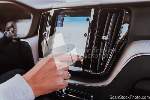 Image of Close-up Of Man Hand Using GPS Navigation Inside Car