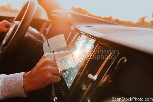 Image of Close-up of a man's finger adjusting autopilot on the touch screen