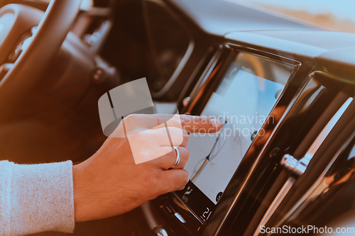 Image of Close-up Of Man Hand Using GPS Navigation Inside Car