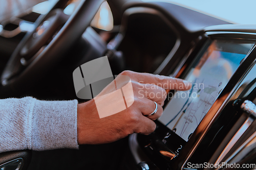 Image of Close-up Of Man Hand Using GPS Navigation Inside Car