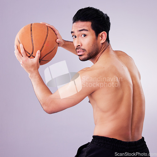 Image of Sports, exercise and basketball with a man playing in studio on a gray background for training or a game. Healthy, body or shirtless and a young male athlete holding a ball for fitness competition