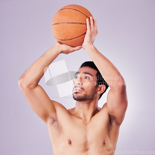 Image of Fitness, basketball and a sports asian man shooting in studio on a gray background for training or a game. Exercise, body or aim and a shirtless young male athlete holding a ball during a competition