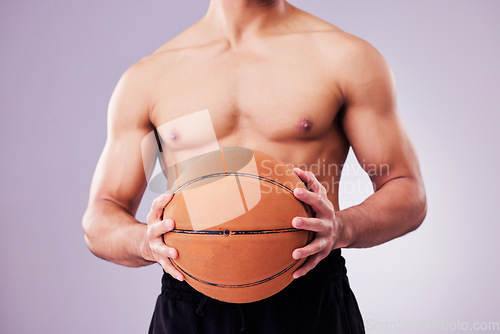 Image of Hands, basketball and a shirtless sports man in studio on a gray background for training or a game. Exercise, workout or body and a male athlete holding a ball while posing topless for fitness