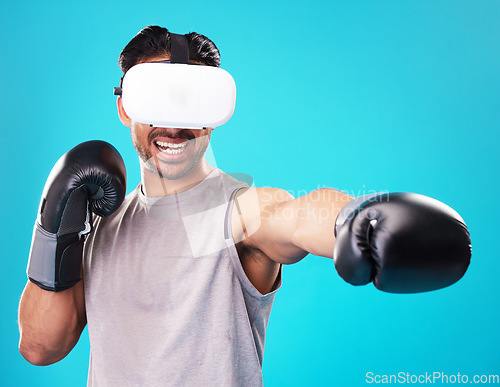 Image of Boxer man, virtual reality glasses and studio with punch, power and workout with 3D user experience. Metaverse boxing, online gaming and gloves for ar exercise, health or training by blue background