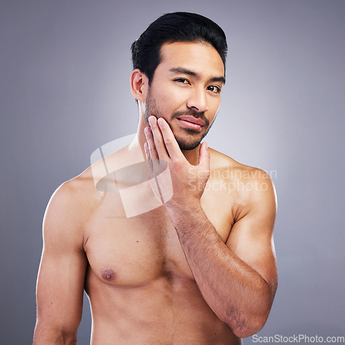 Image of Portrait, skincare and man with muscle body, cosmetics and dermatology on a grey studio background. Face, male person or model with self care, beard treatment or facial with wellness, shine or health