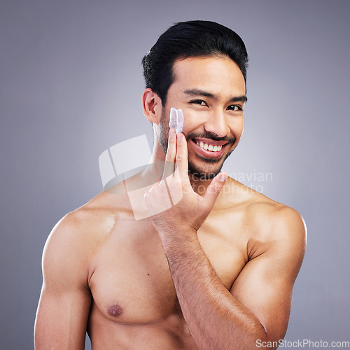 Image of Beauty, skincare or portrait of happy man with face cream or sunscreen product in grooming routine with cosmetics. Dermatology, studio background or male model smiling or applying facial cream lotion