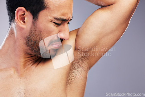 Image of Armpit, stink and man with body odor in studio isolated on a white background for deodorant, cleaning and skincare cosmetic. Underarm, bad smell and model with hyperhidrosis, sweating or poor hygiene