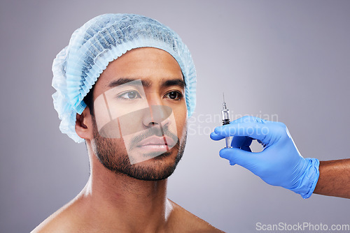 Image of Hand, face and plastic surgery with a man in studio on a gray background for silicon injection. Facelift, beauty and transformation with a male customer in a clinic for antiaging filler or cosmetics