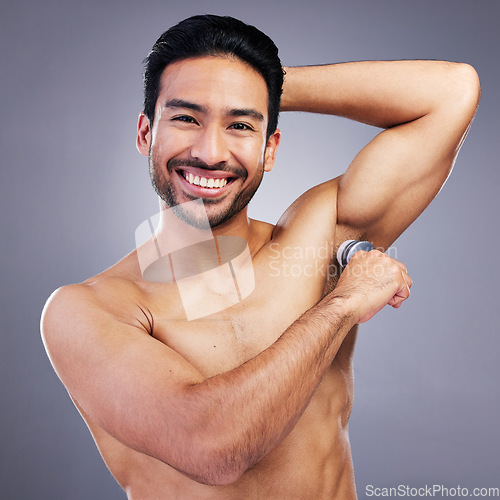 Image of Portrait, man and deodorant on clean armpit for hygiene, routine and control of sweat with beauty product on studio background. Antiperspirant, skin or smell, scent and skincare perfume or cosmetics