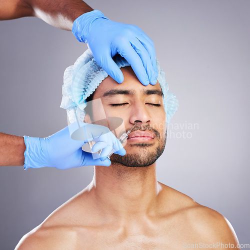 Image of Hands, face and change with a man in studio on a gray background for a silicon injection. Beauty, plastic surgery or transformation with a male customer in a clinic for antiaging filler and cosmetics