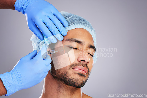 Image of Hands, aesthetic and plastic surgery with a man in studio on a gray background for silicon injection. Facial, beauty or transformation with a male customer in a clinic for antiaging filler or implant