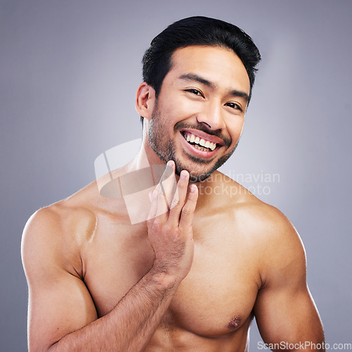 Image of Portrait, skincare and man with cosmetics, facial and dermatology on grey studio background. Face, male person or happy Asian model with grooming, body muscle and health with wellness, beard or glow