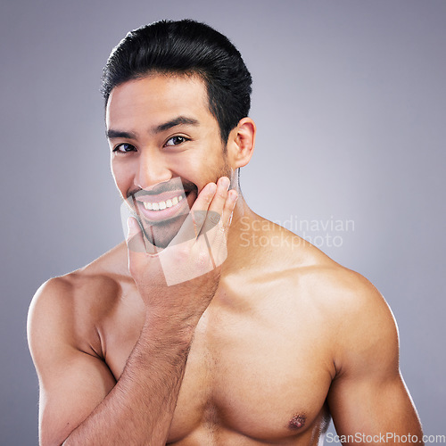 Image of Portrait, skincare and man with beauty, dermatology and wellness against a grey studio background. Face, male person or happy model with self care, beard and health with wellness, cosmetics and shine