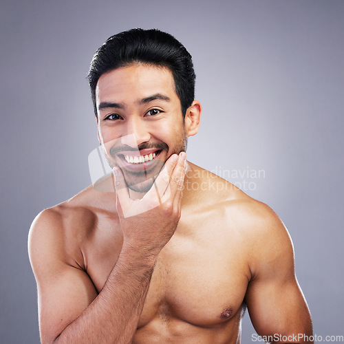 Image of Portrait, skincare and man with facial, cosmetics and natural beauty against a grey studio background. Face, male person and model with grooming routine, muscle and health with wellness and aesthetic