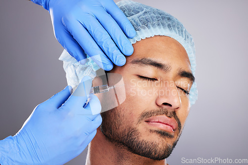 Image of Hands, implant and plastic surgery with a man in studio on a gray background for a silicon injection. Face, beauty and transformation with a male customer in a clinic for antiaging dermatology filler