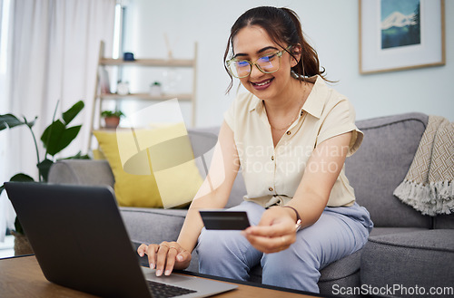 Image of Woman, credit card and ecommerce on laptop in home for digital payment, fintech password and online shopping. Happy female customer, computer and banking code for financial bills, budget and account