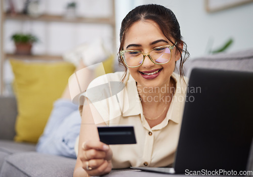 Image of Woman, credit card and finance with laptop on sofa for digital payment, fintech password and online shopping. Happy female customer, computer and banking code for financial sales investment at home