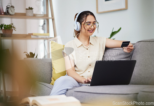 Image of Woman, credit card and laptop with headphones in home for digital payment, fintech password and online shopping. Happy female customer, computer account and banking code to upgrade music subscription