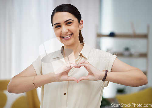 Image of Portrait, heart and hands of woman in home for care, charity and kindness on valentines day. Happy female person with finger shape for love icon, thank you and emoji in support of freedom in lounge