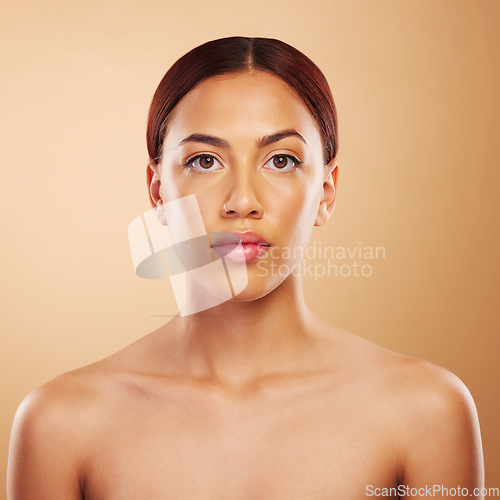 Image of Portrait, skincare and woman with cosmetics, beauty and wellness against a brown studio background. Face, female person and model with makeup, aesthetic and self care with health, glowing and shine