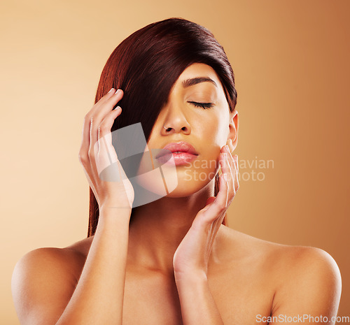 Image of Hair care, beauty and a woman in studio for salon, hairdresser and wellness results. Self care, cosmetics and shampoo for growth and shine of an aesthetic model person on a brown background