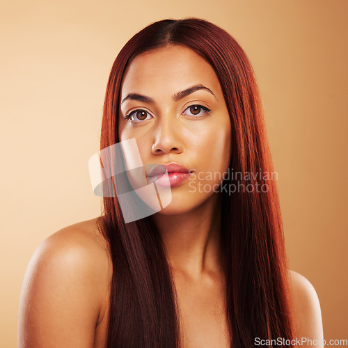 Image of Hair care, natural beauty and portrait of serious woman with glow, luxury salon treatment and brown background. Aesthetic, haircut and haircare, face of model with cosmetics and keratin in studio.