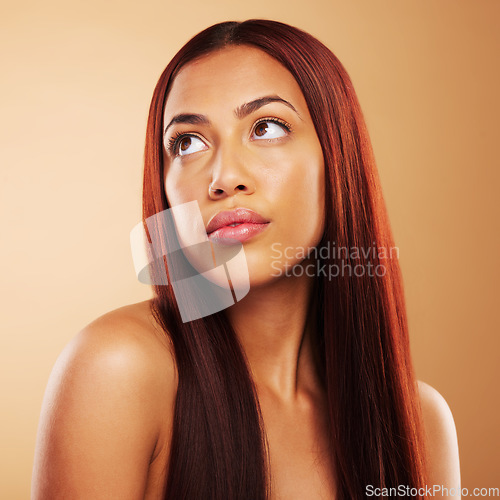 Image of Hair care, natural beauty and thinking, woman with keratin glow and luxury salon treatment on brown background. Idea, haircut and haircare, face of model with cosmetics and healthy shine in studio.