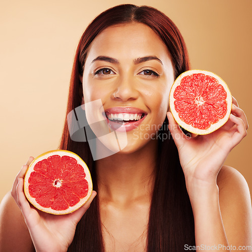 Image of Grapefruit, beauty and portrait of a woman with skin care in studio for dermatology and cosmetics. Natural facial, fruit and healthy diet for detox or vitamin c of a person on a brown background