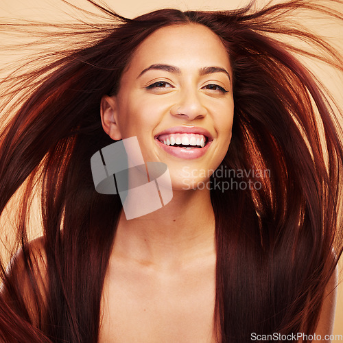 Image of Wind, beauty or portrait of happy woman with hair care after salon treatment isolated on brown background. Natural glow, breeze and face of proud model with cosmetics, smile or hairstyle in studio