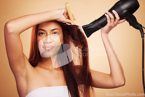 Image of Hair care, happy and portrait of a woman with a dryer for beauty, styling and treatment. Smile, health and a young girl or model with tools for drying hairstyle isolated on a studio background