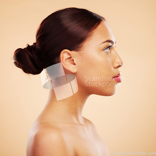 Image of Skincare, makeup and side face of a woman on a studio background for natural and healthy wellness. Serious, facial and a girl with beauty, cosmetics and showing headshot profile on a backdrop