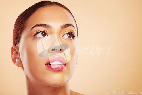 Image of Face, skincare and beauty of woman thinking in studio isolated on a brown background mockup space. Cosmetic, health and serious model with spa facial treatment for dermatology, aesthetic or wellness