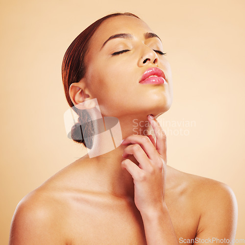 Image of Beauty, skincare touch and woman with eyes closed in studio isolated on brown background. Face, makeup cosmetics and natural model touch neck after spa facial treatment for wellness and healthy skin