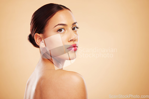 Image of Portrait, beauty and woman with skincare, cosmetics and dermatology against a brown studio background. Face, female person or model with natural makeup and healthy skin with shine, glow and aesthetic